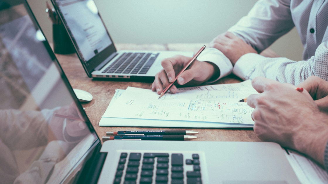 Colleagues looking at statistics. Photo by Scott Graham on Unsplash