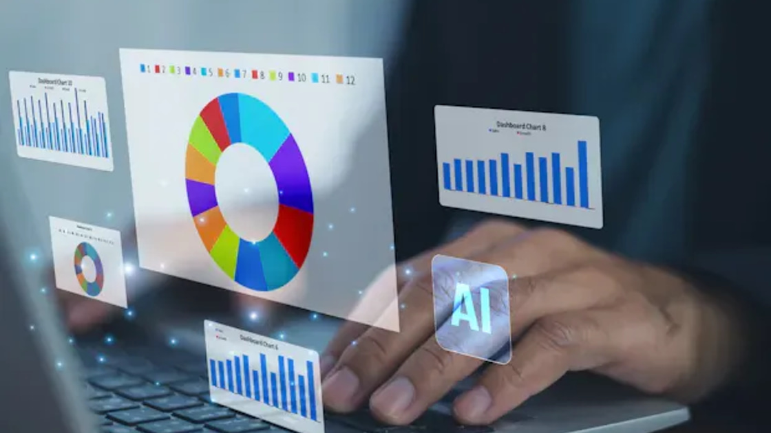 A person types on a laptop while translucent holographic dashboard panels of bar, line, and donut charts float above the keyboard beside a glowing AI icon.