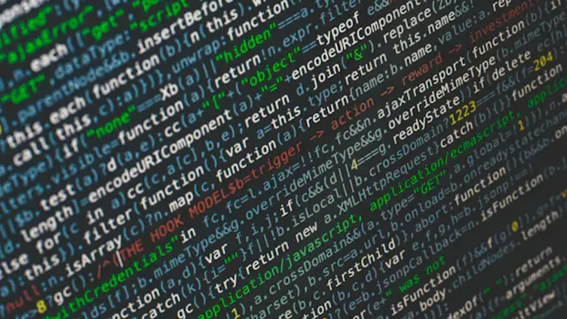 Close-up of colorful JavaScript source code displayed on a dark screen.