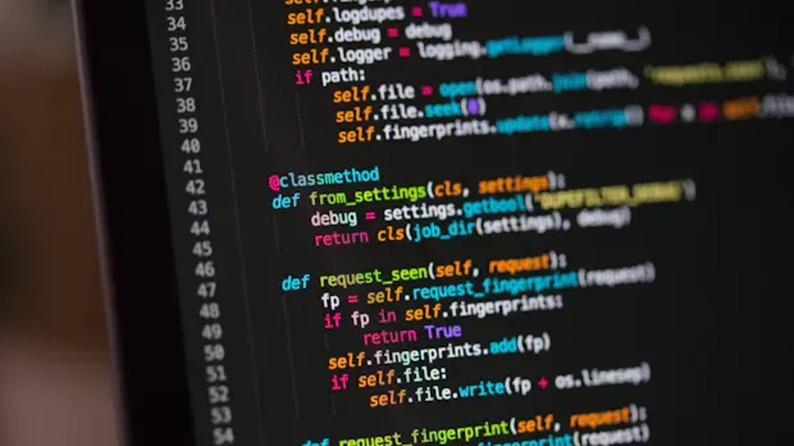 Close-up of code displayed on a dark monitor screen