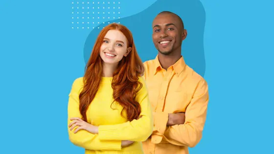 Two smiling Seamless.AI colleagues standing arms crossed against a blue background
