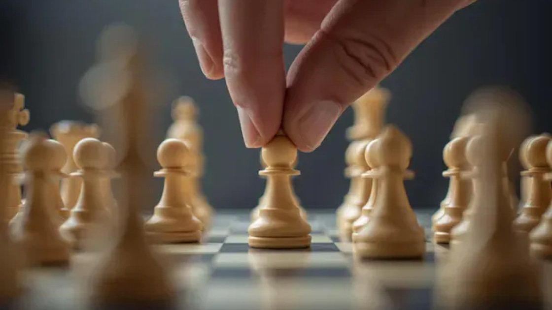 A hand moves a white pawn forward across a chessboard of pawns, evoking the first strategic move in choosing a data quality vendor.