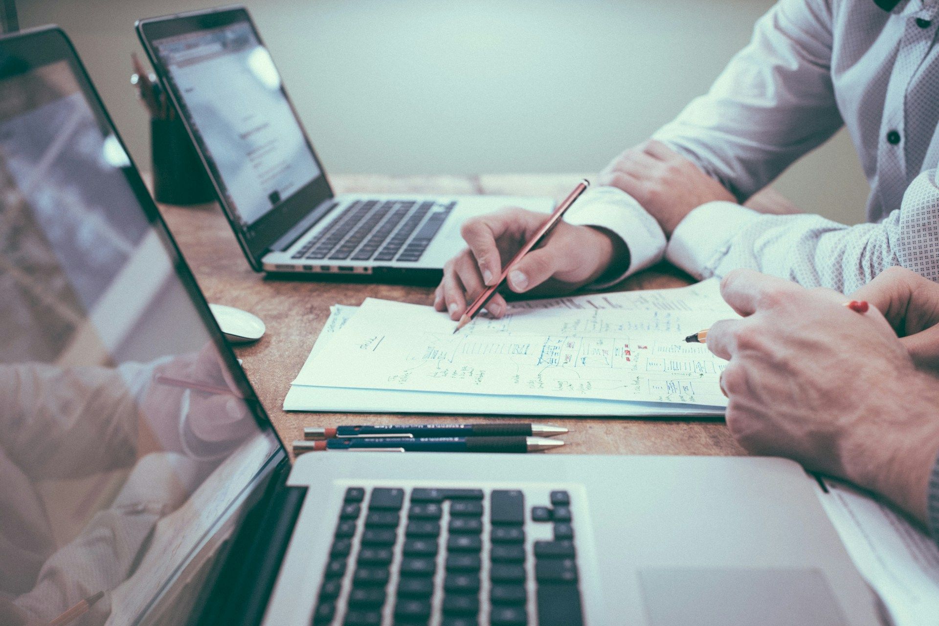 Colleagues looking at statistics. Photo by Scott Graham on Unsplash