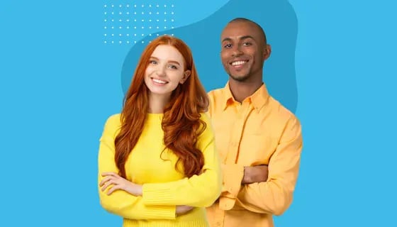 Two smiling Seamless.AI colleagues standing arms crossed against a blue background