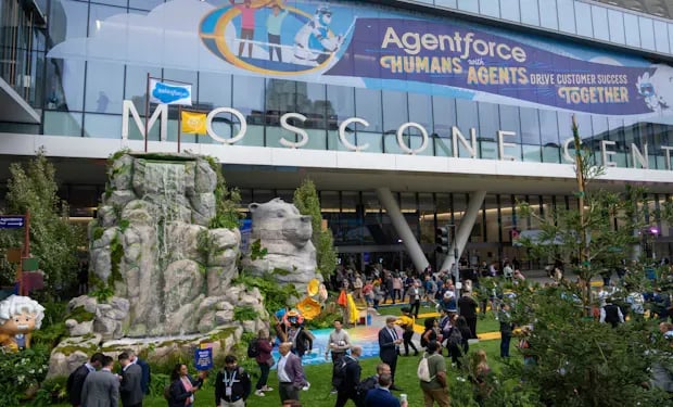 Attendees gather in Dreamforce's Campground area outside Moscone Center, with a rock-and-waterfall display and an Agentforce banner above the entrance.