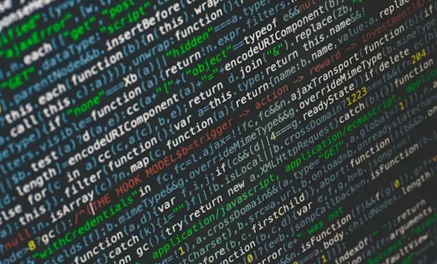 Close-up of colorful JavaScript source code displayed on a dark screen.