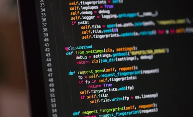 Close-up of code displayed on a dark monitor screen